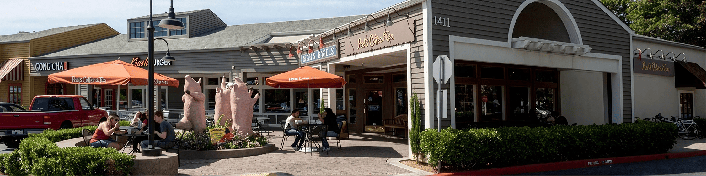 Outdoor shopping center with orange umbrellas