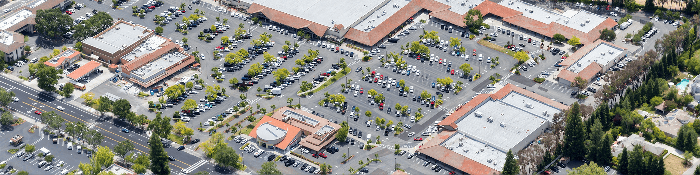 Busy commercial area with parked cars.
